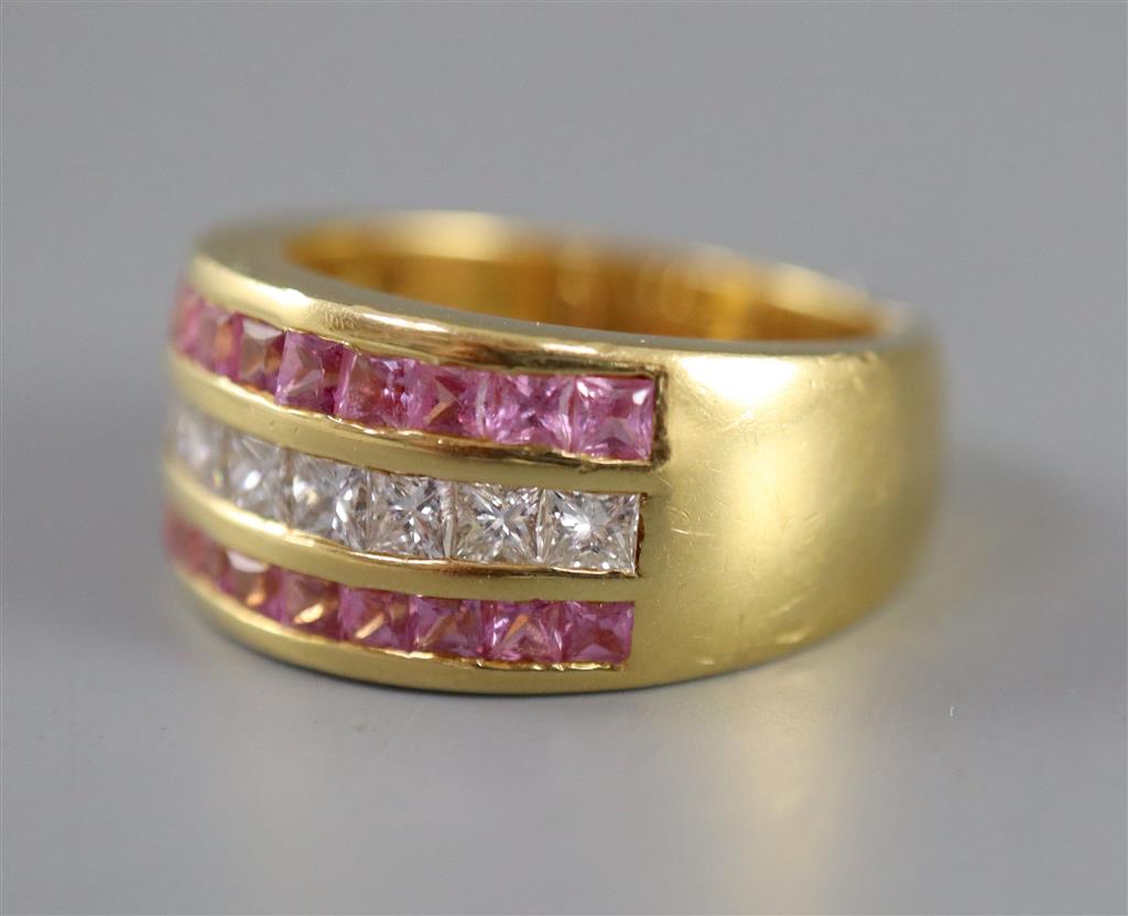 A modern 18ct gold, diamond and pink sapphire set three row dress ring,